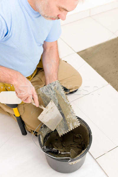 Stock photo: Home improvement, renovation - handyman laying tile