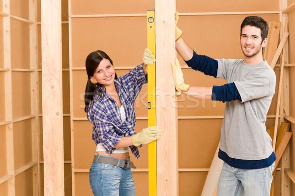 Stock photo: Home improvement smiling couple with spirit level