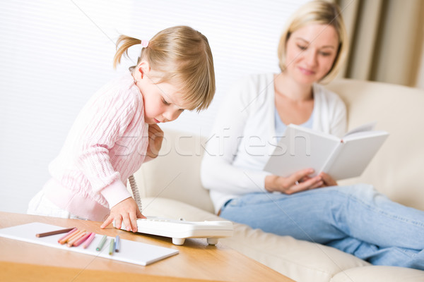 Little girl dial number on phone in living room Stock photo © CandyboxPhoto