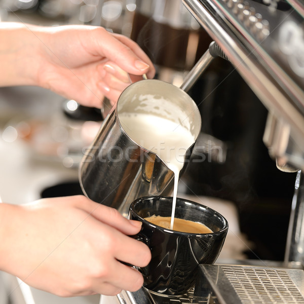 Waitress hands pouring milk making cappuccino Stock photo © CandyboxPhoto