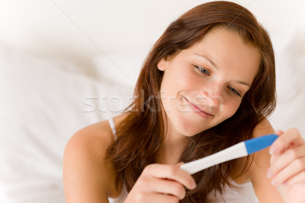 Stock photo: Pregnancy test - happy surprised woman