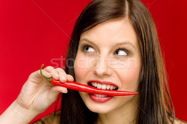Portret młoda kobieta gryźć czerwony pikantny Zdjęcia stock © CandyboxPhoto