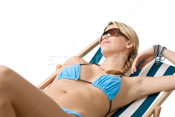 Beach - Young woman in bikini lying on deck chair Stock photo © CandyboxPhoto