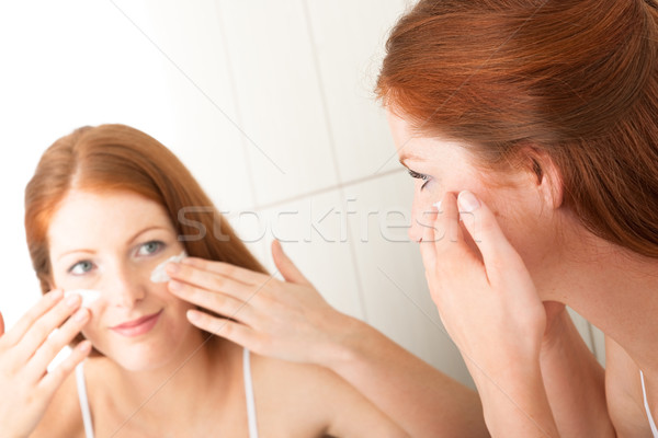 Stock photo: Body care series - Attractive young woman applying cream