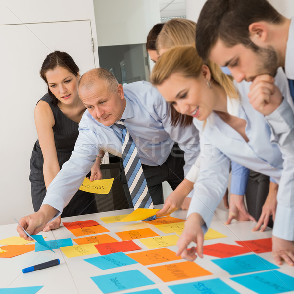 Stock photo: Business Colleagues Arranging Labels On Table