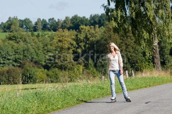Inline skating young woman on sunny asphalt road Stock photo © CandyboxPhoto
