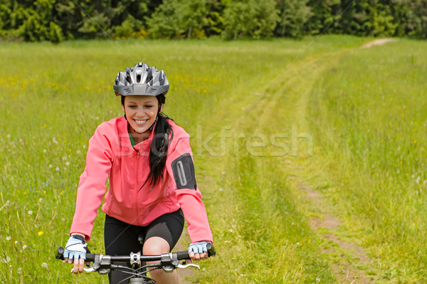 Woman riding bicycle on meadow path Stock photo © CandyboxPhoto