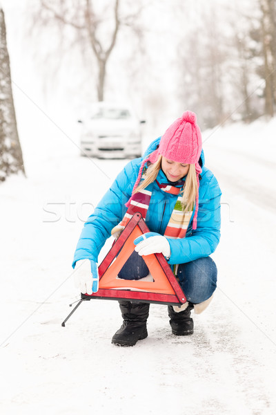 Stock photo: Woman put reflector triangle car breakdown winter