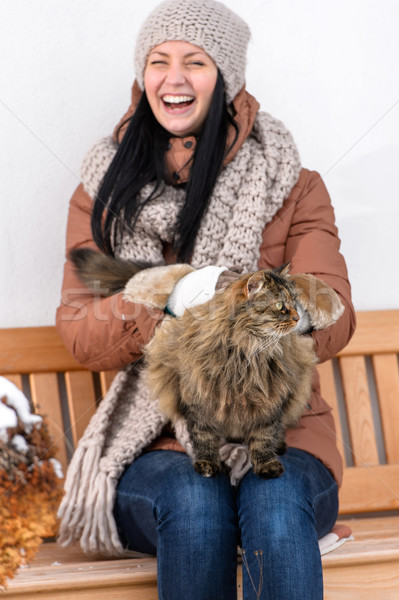 Young woman stroking cat sitting winter bench Stock photo © CandyboxPhoto