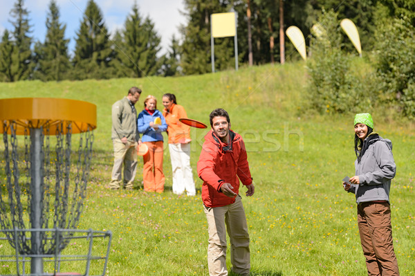 Couple throwing frisbee disc at springtime park Stock photo © CandyboxPhoto