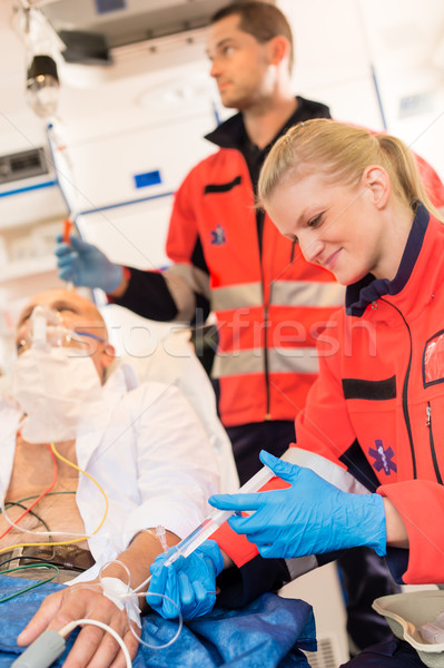Paramedics injecting sick patient in ambulance aid Stock photo © CandyboxPhoto