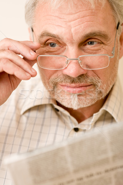 Stock photo: Senior mature man with glasses and newspaper