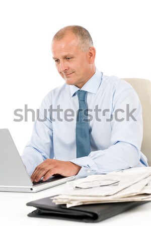 Stock photo: Happy businessman working in office behind desk
