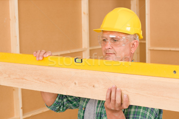 Handyman mature professional with spirit level Stock photo © CandyboxPhoto