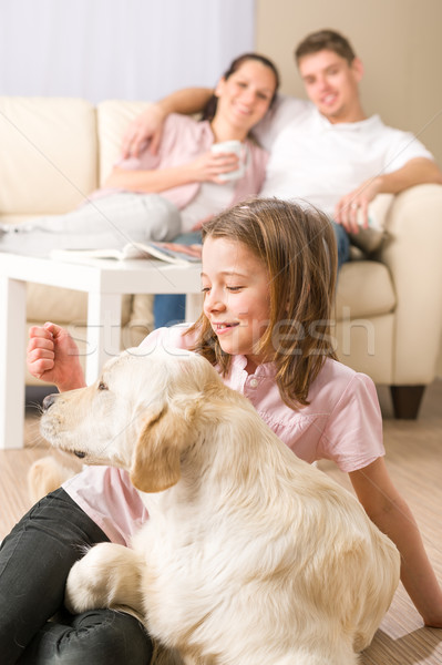 Playful girl petting family dog with parents Stock photo © CandyboxPhoto