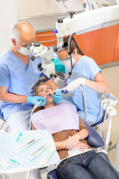 Dentist operating patient through microscope  Stock photo © CandyboxPhoto