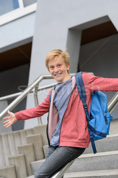 Stock photo: Excited student sliding down railing on stairway