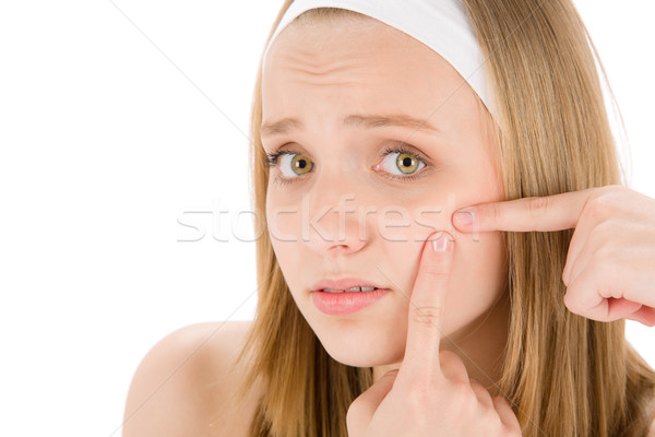 Stock photo: Acne facial care teenager woman squeezing pimple