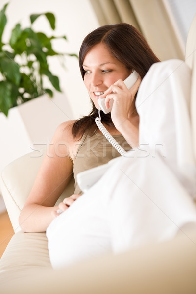 Telefon otthon fiatal nő hív társalgó fekszik Stock fotó © CandyboxPhoto