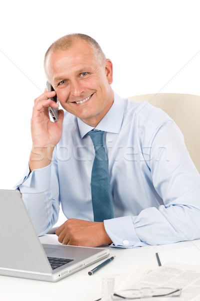 Smiling businessman sitting in office behind desk Stock photo © CandyboxPhoto
