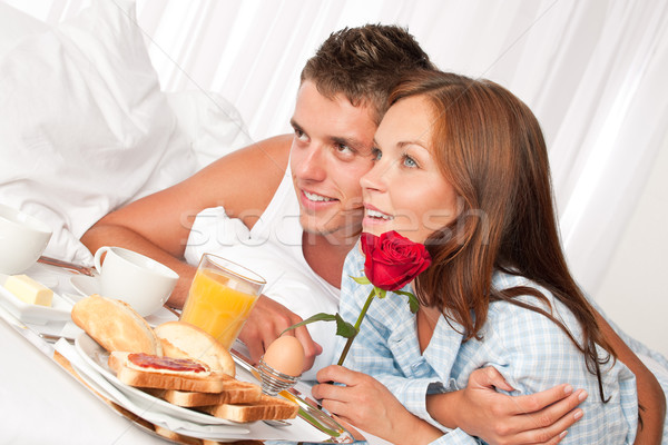 Happy man and woman having breakfast in bed together Stock photo © CandyboxPhoto