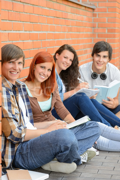 College students sitting outside by brick wall Stock photo © CandyboxPhoto
