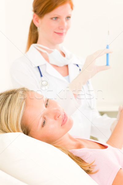 Medical doctor apply injection to woman patient Stock photo © CandyboxPhoto
