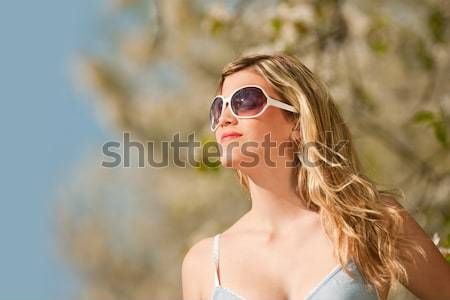 Spring - Young woman under blossom tree enjoy sun Stock photo © CandyboxPhoto