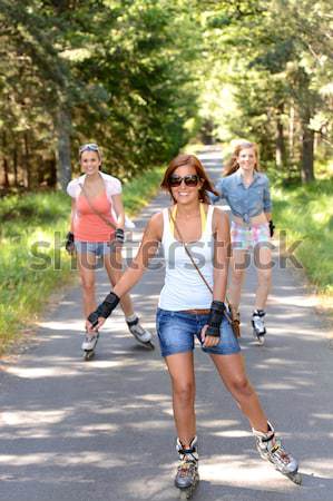 Young woman roller skating outdoors with friends Stock photo © CandyboxPhoto