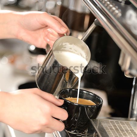 Waitress hands pouring milk making cappuccino Stock photo © CandyboxPhoto