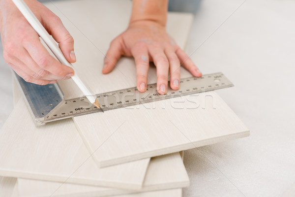 Stock photo: Home improvement - handywoman measuring tile