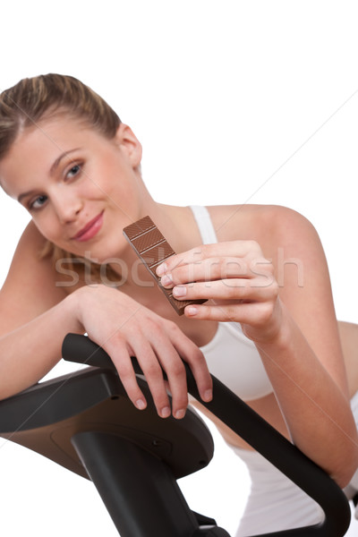 Stock photo: Fitness series - Woman holding piece of chocolate