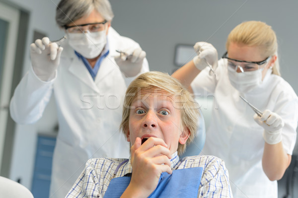 Scared teenage patient frighten dentist and nurse Stock photo © CandyboxPhoto