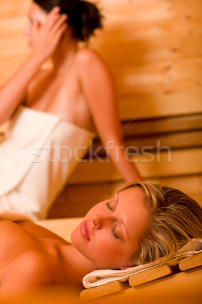 Stock photo: Sauna two women relaxing sweating covered towel