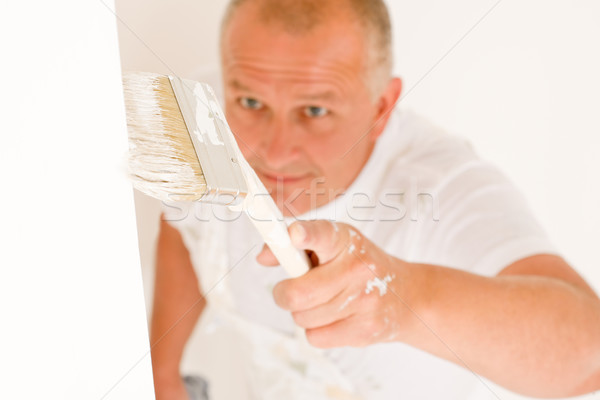 Home decorating mature man painting wall brush Stock photo © CandyboxPhoto