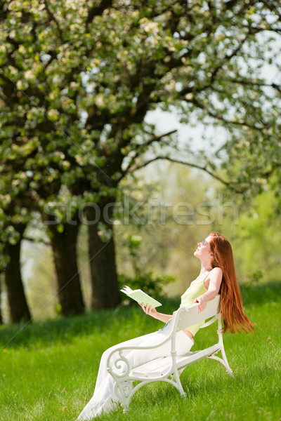 Stock photo: Young woman relaxing under blossom tree in spring