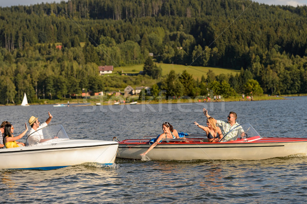 Stock photo: Young friends having fun in motorboats