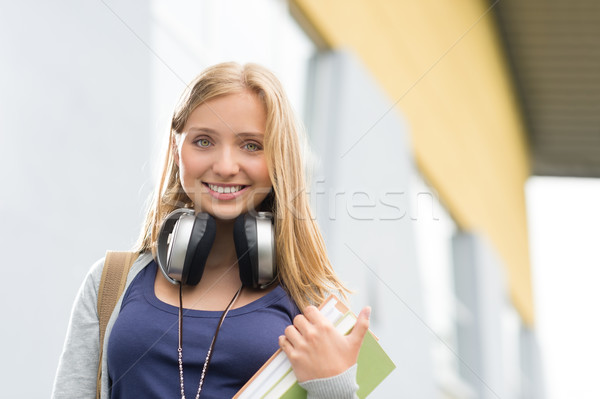 Student girl with headphones smiling at camera Stock photo © CandyboxPhoto