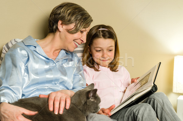 Grandmother and girl looking at photo album Stock photo © CandyboxPhoto