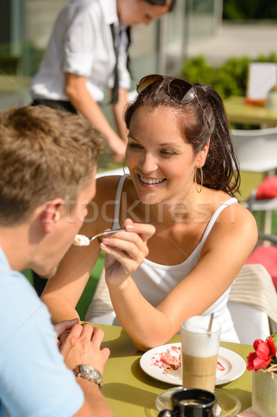 Stock photo: Woman feeding man cheesecake at cafe couple