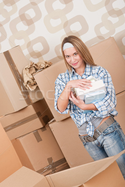 Moving house: Woman unpacking box with book Stock photo © CandyboxPhoto