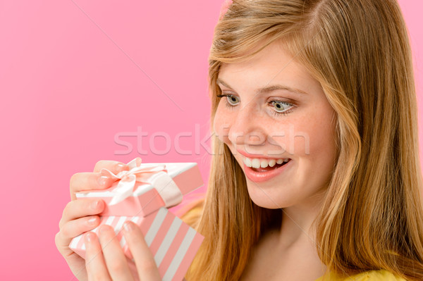 Elated girl opening gift Stock photo © CandyboxPhoto