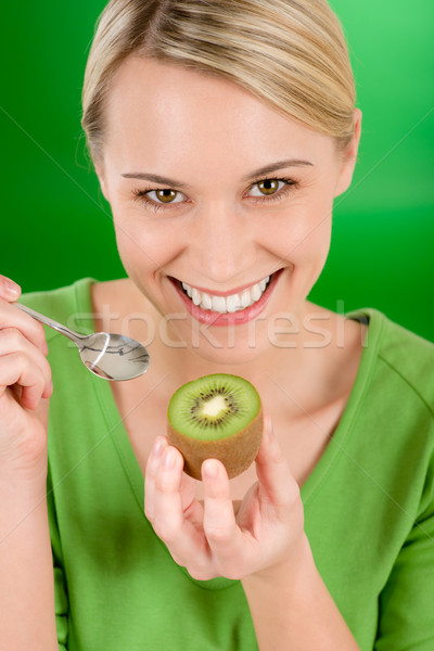 Healthy lifestyle - happy woman holding kiwi on green Stock photo © CandyboxPhoto