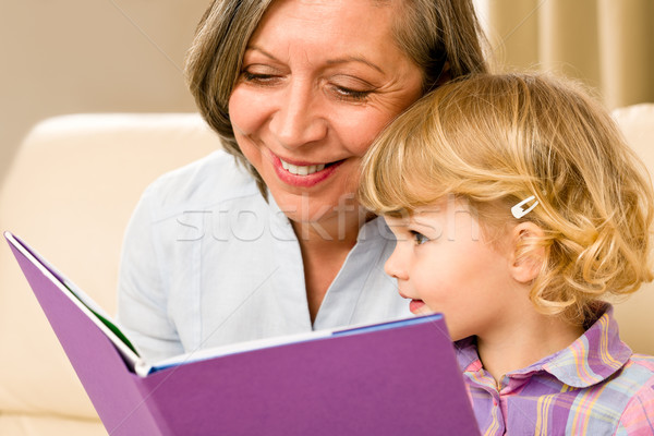 Grandmother and granddaughter read book together Stock photo © CandyboxPhoto