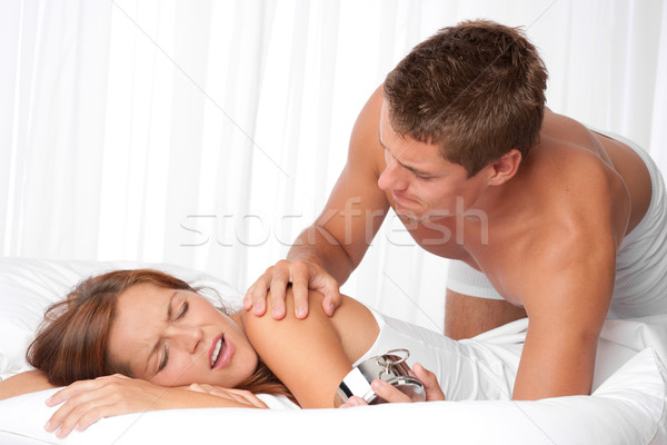 Young man waking up woman in white bed Stock photo © CandyboxPhoto