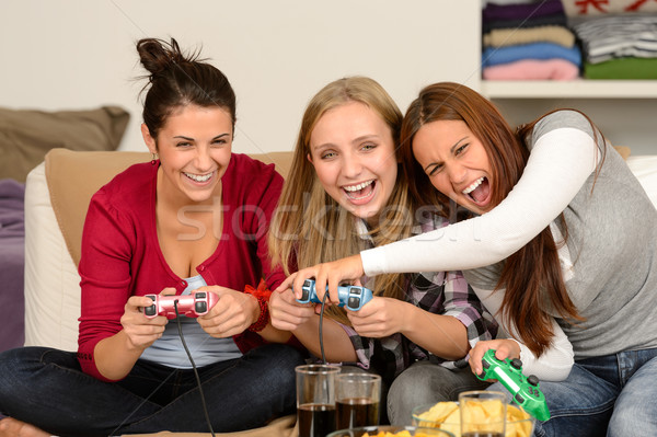 Laughing young girls playing with video games Stock photo © CandyboxPhoto