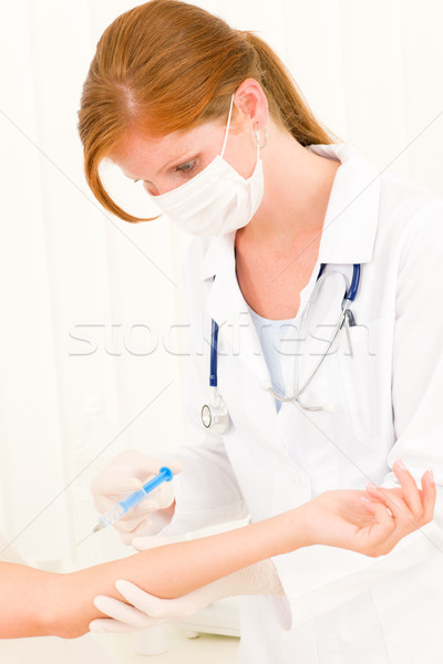 Stock photo: Medical female doctor apply injection to  patient