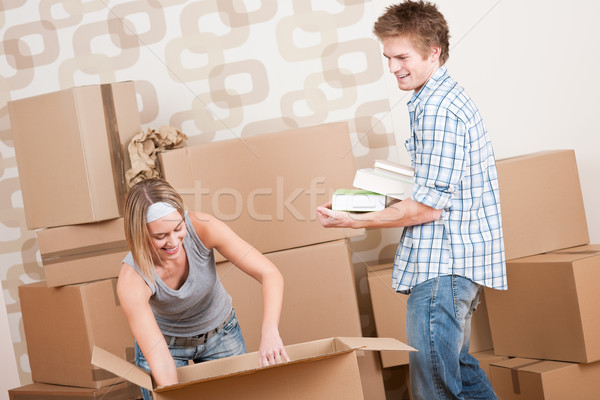 Moving house: Young couple with box in new home Stock photo © CandyboxPhoto