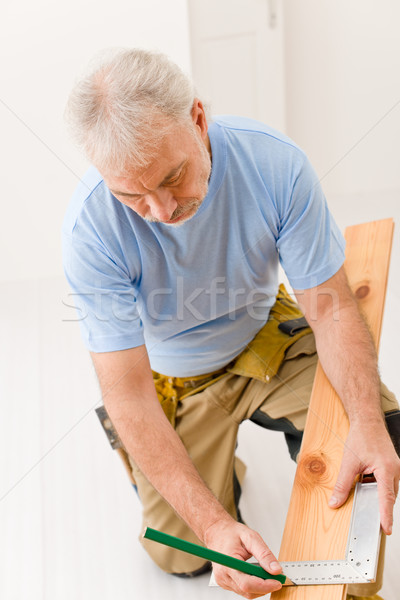 Stock photo: Home improvement - handyman installing wooden floor