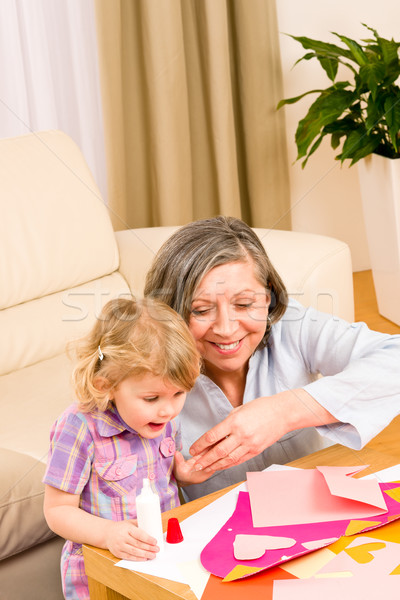 Little girl with grandmother play glue paper Stock photo © CandyboxPhoto